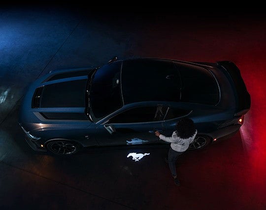 2024 Ford Mustang® Dark Horse™ model with a driver approaching the vehicle | York Ford Sales in Houlton ME