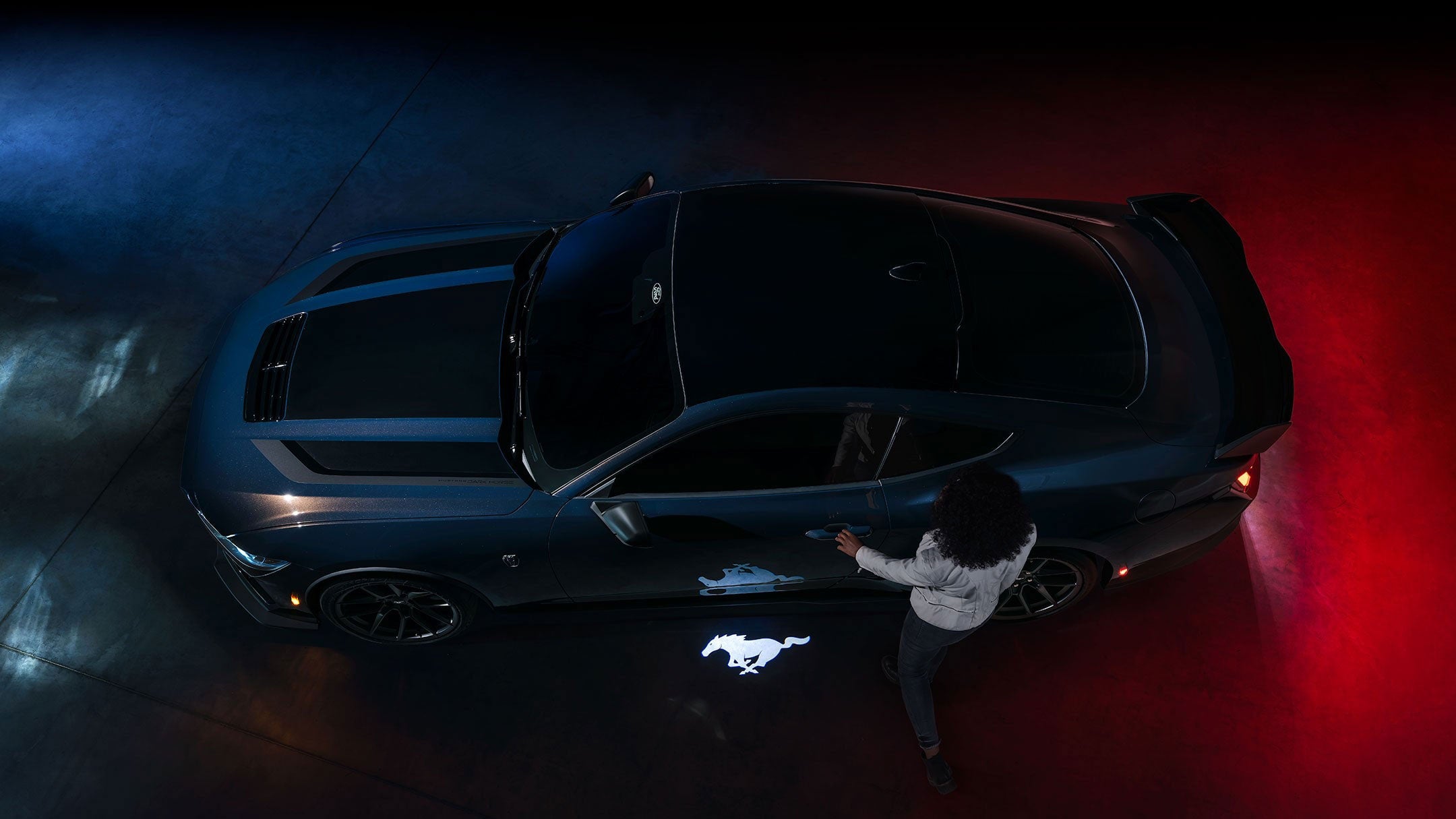 2024 Ford Mustang® Dark Horse™ model with a driver approaching the vehicle | York Ford Sales in Houlton ME