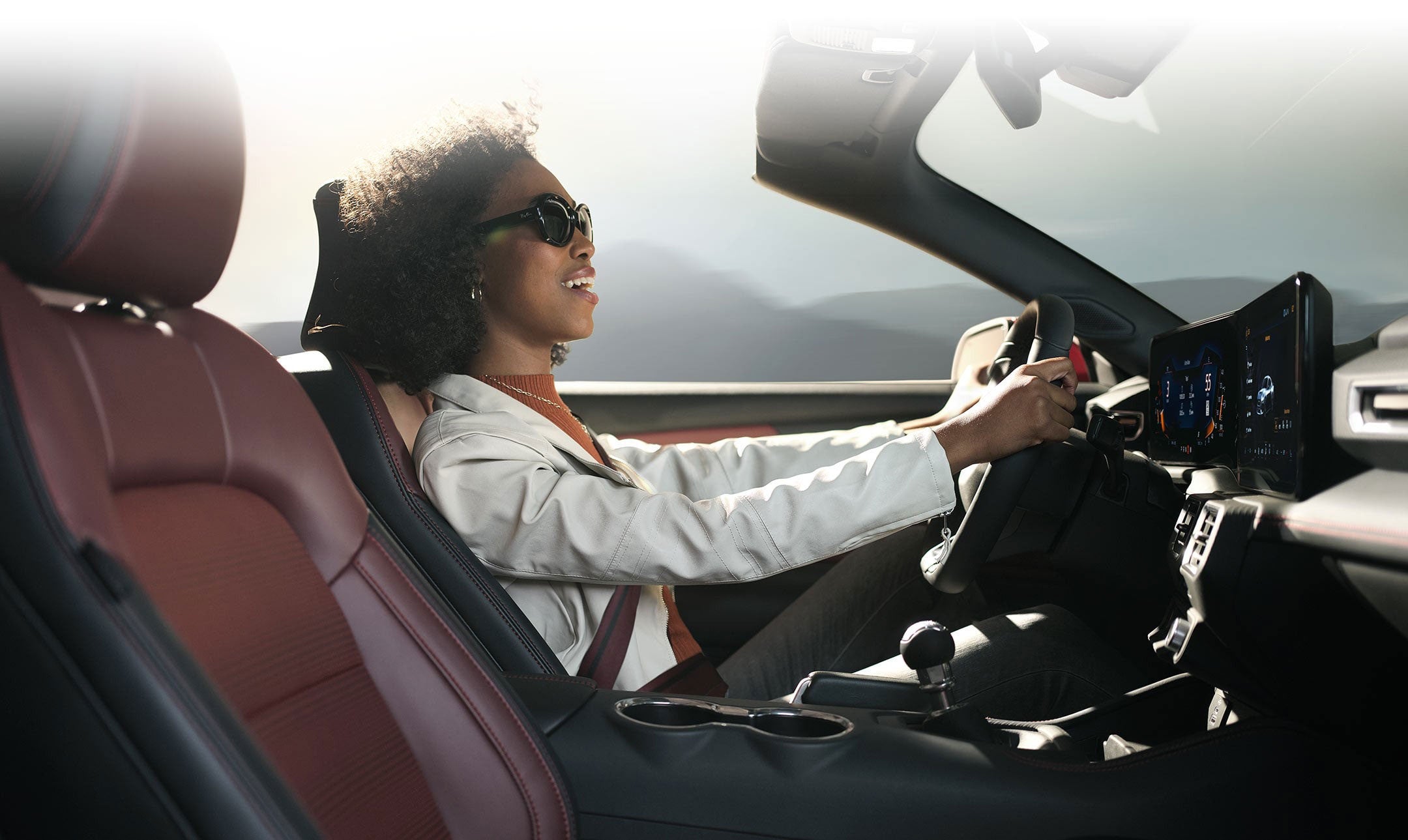 Person sitting in the driver’s seat of a 2024 Ford Mustang® convertible | York Ford Sales in Houlton ME