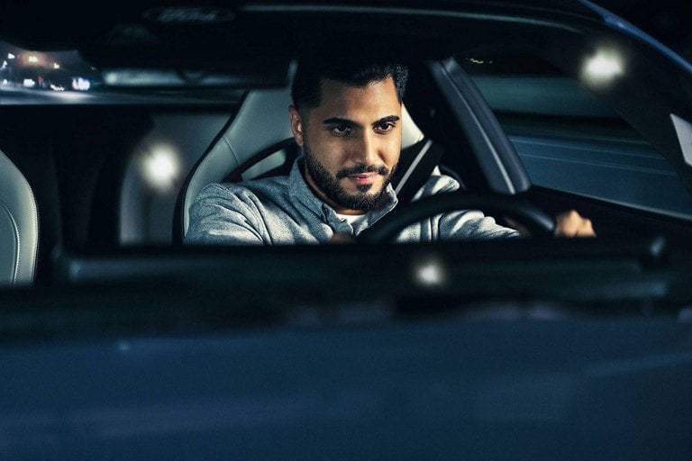 Person sitting in the driver’s seat of a parked 2024 Ford Mustang® coupe | York Ford Sales in Houlton ME